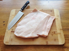 Frozen pork skin with knife